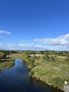 River surrounded by greenery on both sides. 