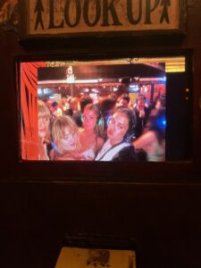 Girls wearing headphones looking into a camera