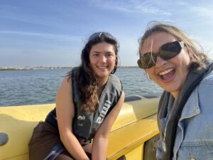 Two girls smiling on a speedboat