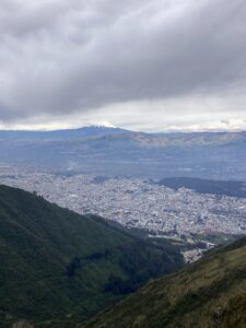A view of the city of Quito from halfway up Rucu Pichincha. The Cotopaxi volcano is visible in the background.