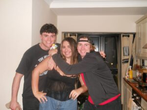 Two boys and a girl standing and smiling