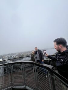 Someone takes a picture of a man taking a picture of a couple 