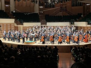 Stage with orchestra standing for applause