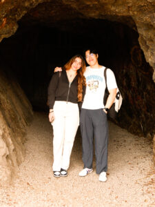 Man and woman at mouth of a cave