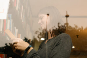 Girl reading books through a window