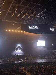 Stage set for Le Sserafim concert, preparations in place and people moving to their seats