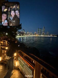 Friends in Busan looking out over the water with a dark blue sky above.