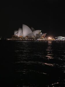 Sydney Opear House reflecting in the water at night from on the Harbour bridge.