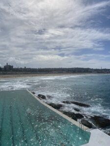 View of the Bondi Beach pool next to the ocean. The waves were crashing on the rocks.