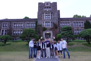 Photo with my friends and I with Yonsei merchandise at the famous Yonsei Sinchon campus underwood building